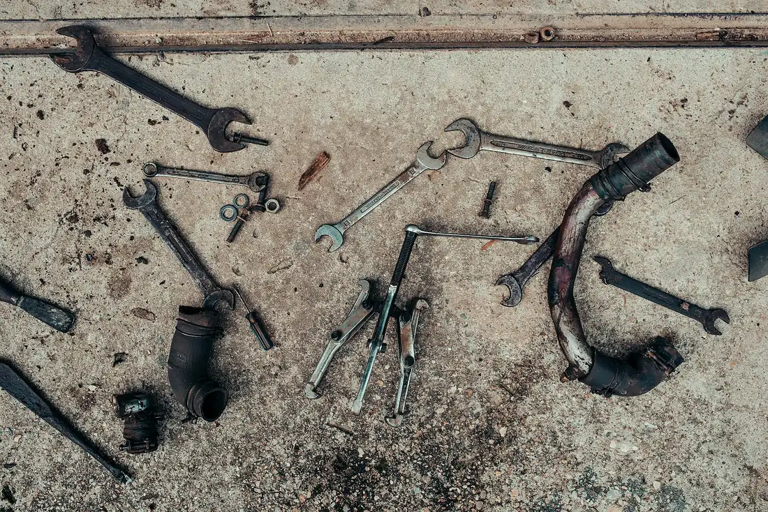 Mechanic's tools and parts on a workshop floor