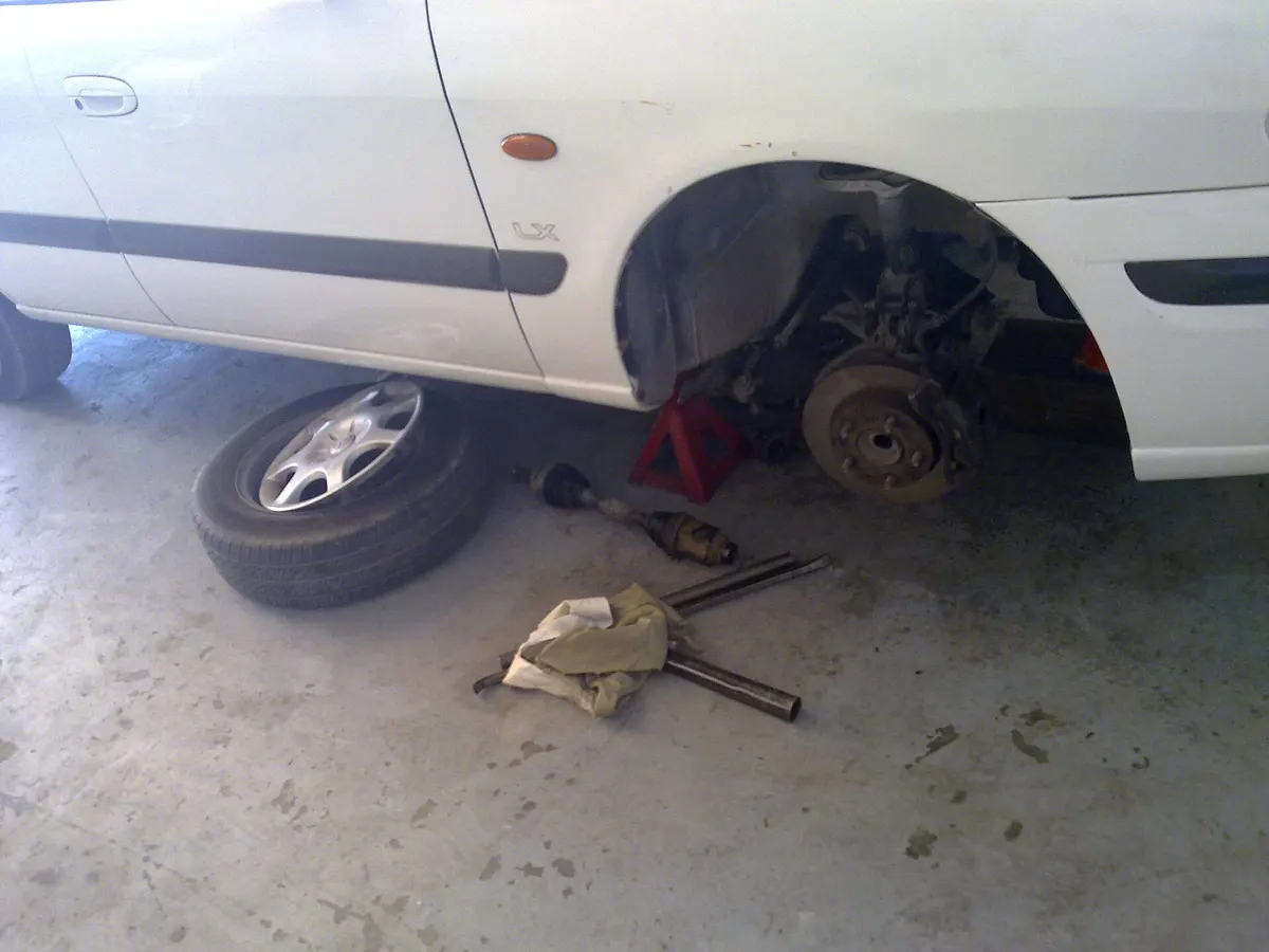 A car with a wheel off, showing the disc brake